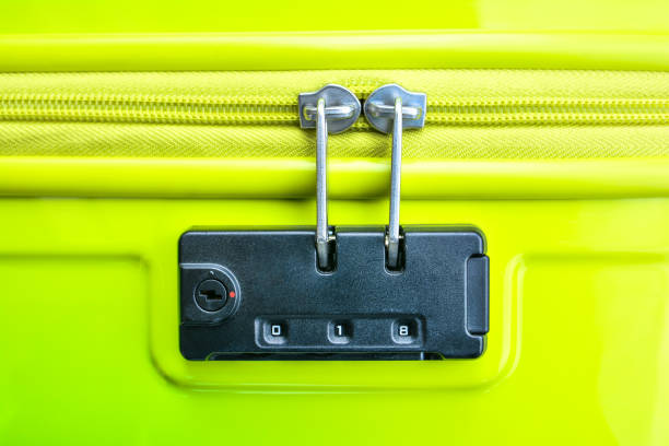 Closeup of a security padlock with three numbers on green suitcase