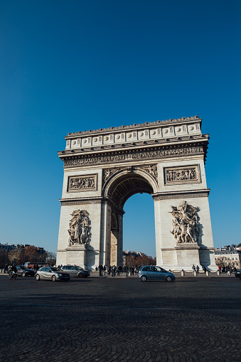 French people and foreigner travlers walk visit Arc de triomphe de l'Etoile or Triumphal Arch of the Star at Place Charles de Gaulle in Paris, France