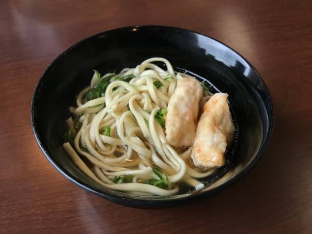 Udon served with kamaboko or fish cake in Okinawa, Japan.