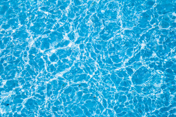 istock Blue ripped water in swimming pool with sunny reflections. 1089287532