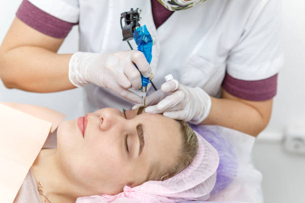istock Permanent makeup, tattooing of eyebrows. Cosmetologist applying make up 1089289826