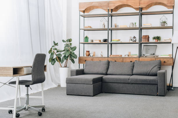 istock modern living room with sofa, racks and workspace 1089295636