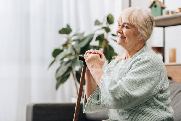 istock cheerful retired woman smiling and holding walking stick 1089296494