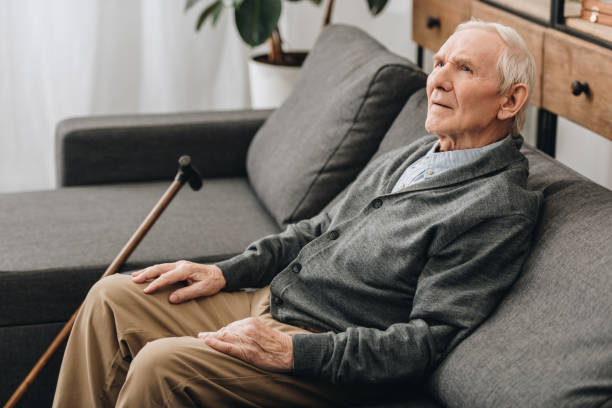 istock thoughtful pensioner with grey hair sitting on sofa 1089296802