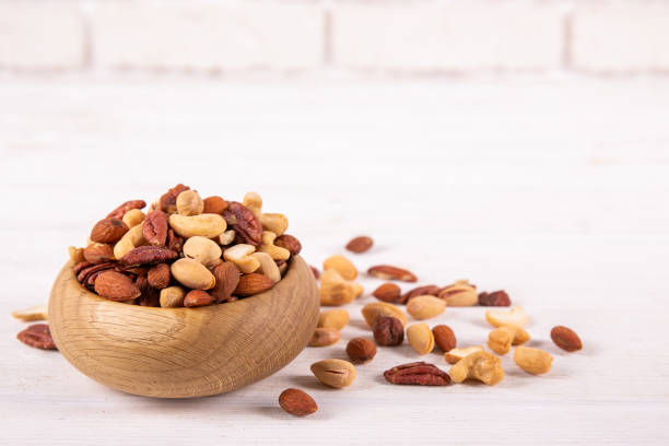 istock Different kinds of organic nuts in wooden bowl. 1089297798