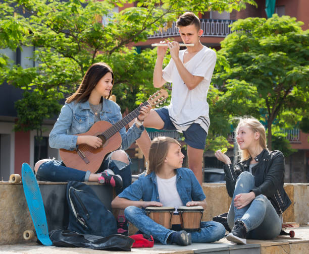 istock Happy teenagers with musical instruments 1089297896