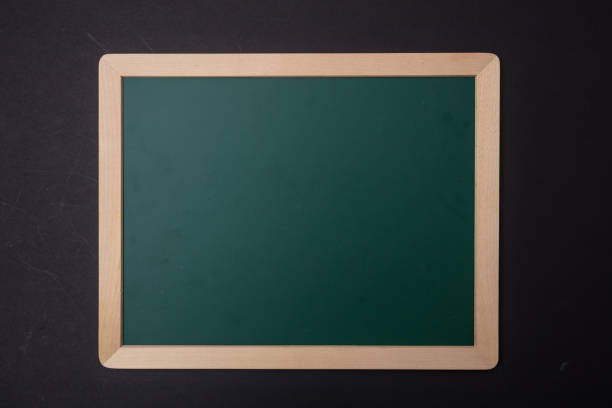 istock Green blank empty chalkboard with wooden frame, black wall background, copy space 1089299198