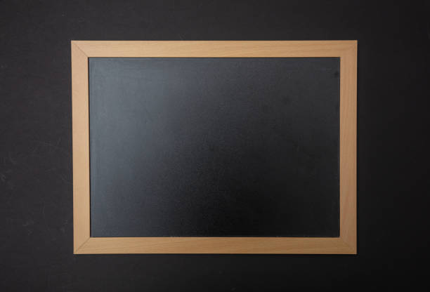 istock Black blank empty blackboard with wooden frame, black wall background, copy space 1089299232