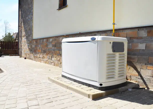 Photo of Residential house natural gas backup generator. Choosing a location for house standby generator.