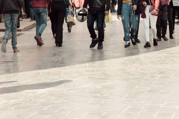 Walking through the street crowd. A crowd of pedestrians crossing street in the city, People walking in the street. Big city life. Crowd walking - group of people walking together (motion blur)