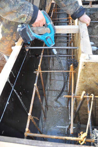 istock Contractor mix concrete in foundation slabs with iron bars. Mixing Concrete Slab Foundation. 1089313444