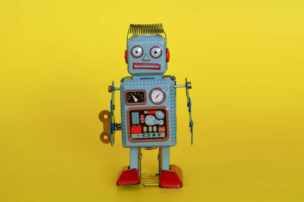 istock Vintage tin toy robot isolated on a yellow background. 1089317788