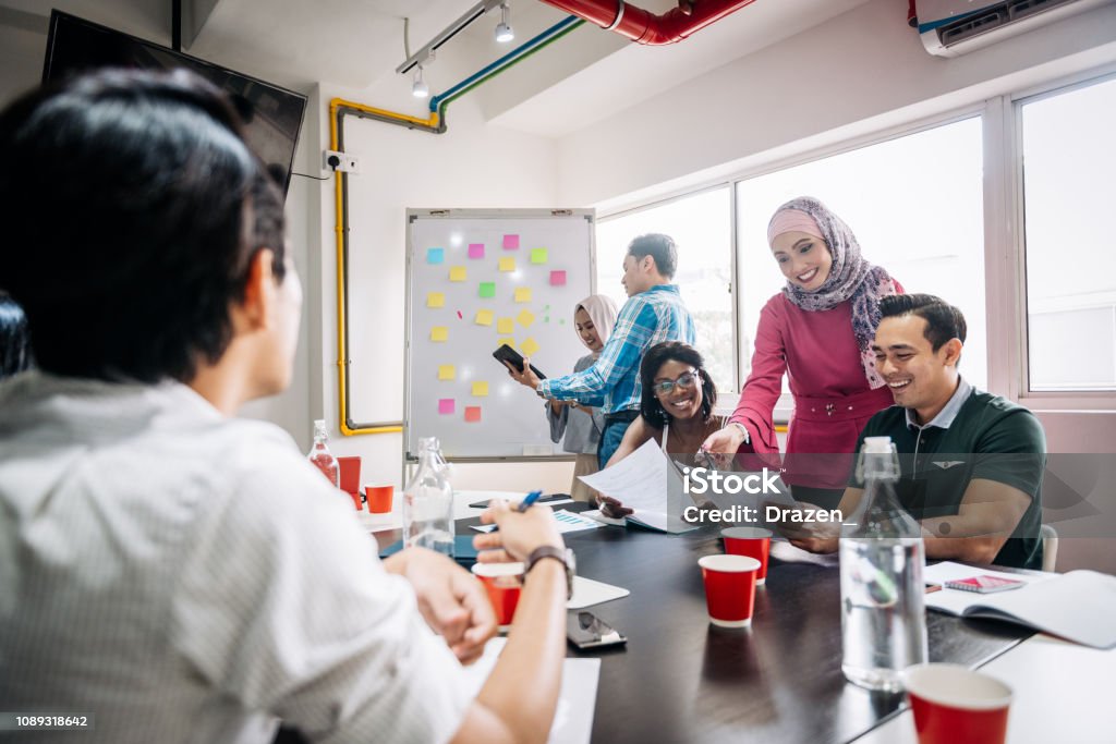 Improvements in human resources in small and medium companies Business development concept and teamwork in new start-up company in South East Asia with ethnically and age diverse business people Change Stock Photo