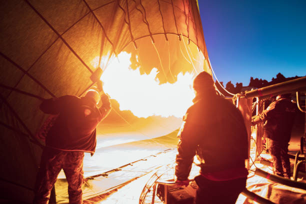 Top-down view of a hot air balloon basket resting on the ground, showcasing burner equipment. Scenic and dynamic scene highlighting adventure, travel, and outdoor experiences