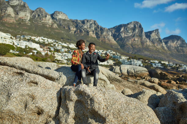 istock Young couple taking selfie while sitting on rock 1089321950