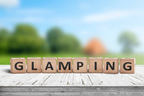 Glamping sign on wooden planks in the summer stock photo