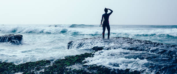 istock Woman surfe with surfboard on mossy coral reefs 1089325072