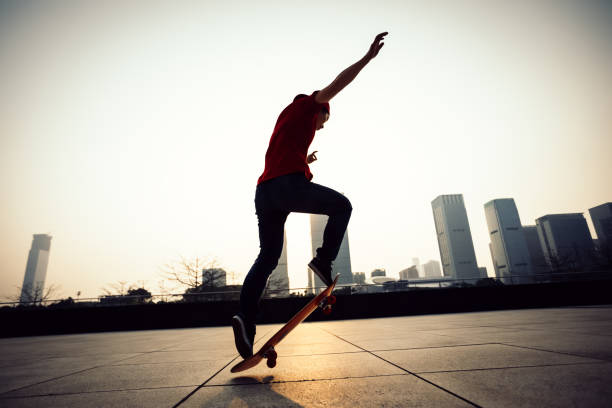 istock Skateboarder skateboarding at sunrise city 1089327446