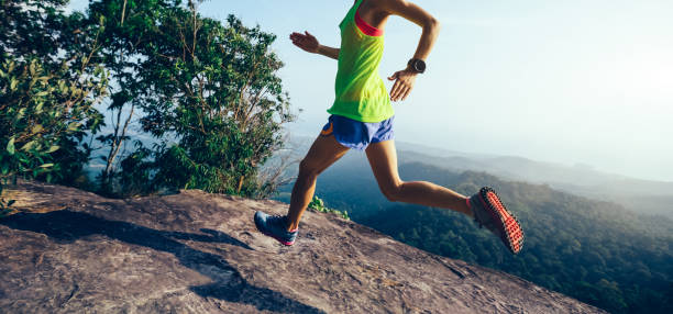 istock Young woman running on mountain peak 1089330346