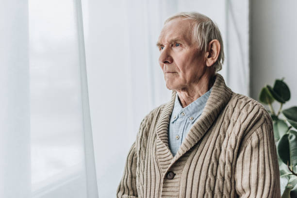 istock upset retired man with dementia disease standing at home 1089332948