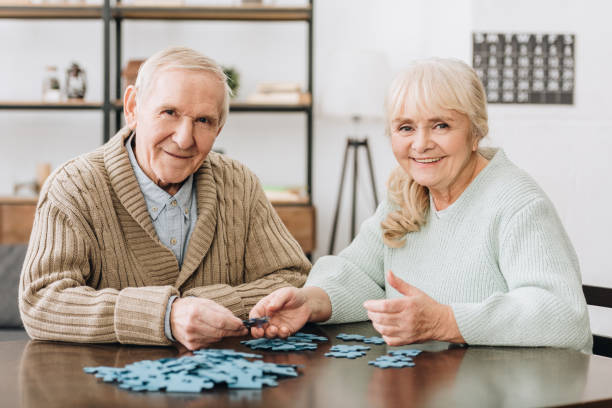 istock cheerful retired couple playing with puzzles at home 1089333000