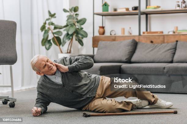 Old Men Falled Down On Floor And Touching Neck Stock Photo - Download Image Now - Falling, Senior Adult, Senior Men