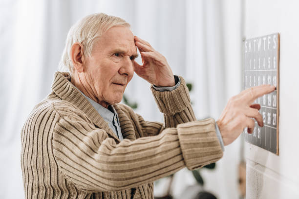 istock senior man looking at wall calendar and touching head 1089334810