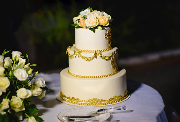 istock wedding cake with fresh flowers roses. three tiers 1089338524
