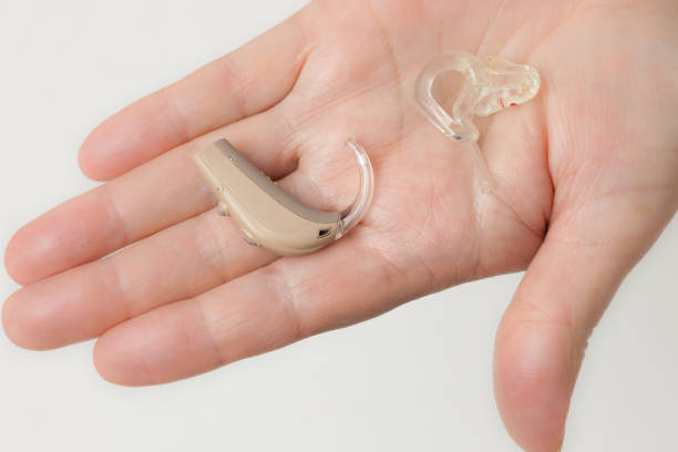 istock senior person holding hearing aid closeup 1089342196