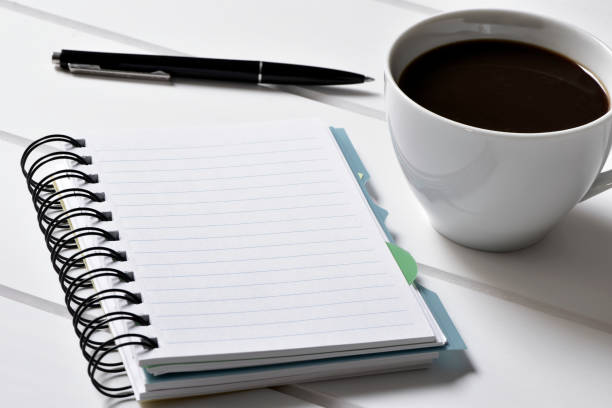 istock blank notebook, pen and cup of coffee 1089343604