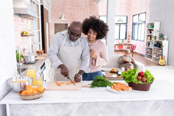 istock Father and daugther preparing dinner at home 1089344266