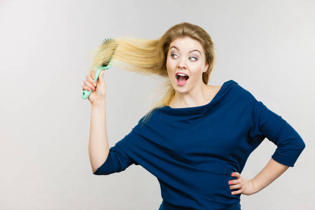istock Woman brushing her long hair with brush 1089344280
