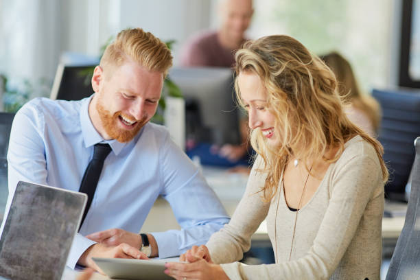 istock Corporate workers sitting in board room ad looking at tablet. 1089346970