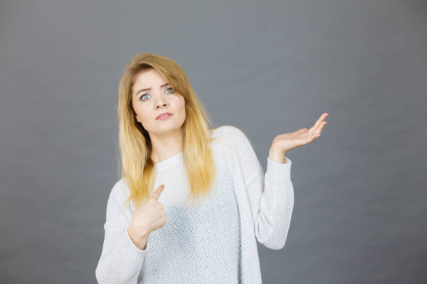 istock Confused young blonde woman gesturing with hands 1089347398