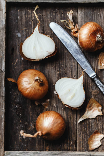 istock Fresh onions on rustic wooden background. Onions background. Ripe onions. 1089350264