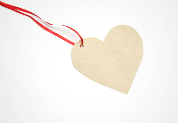 istock heart-shaped paper label on red ribbon on white background 1089356932