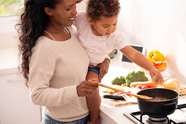 istock Mother and daughter cooking a soup. 1089357640