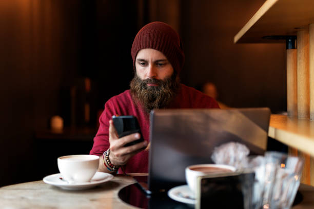 istock Bearded hipster typing on laptop 1089360094