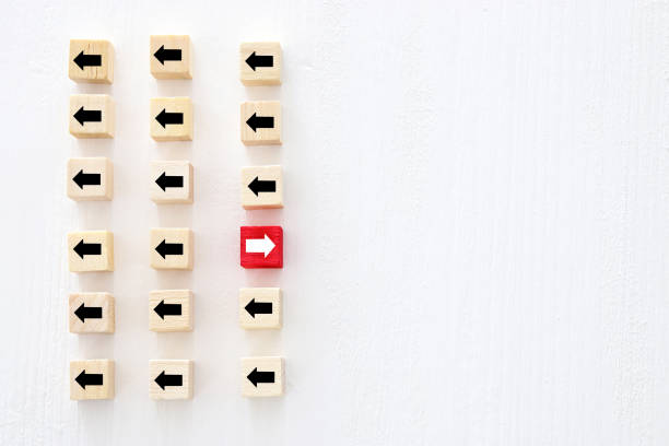 istock concept of think different, innovation and creativity. red cube changing direction from others. 1089361018