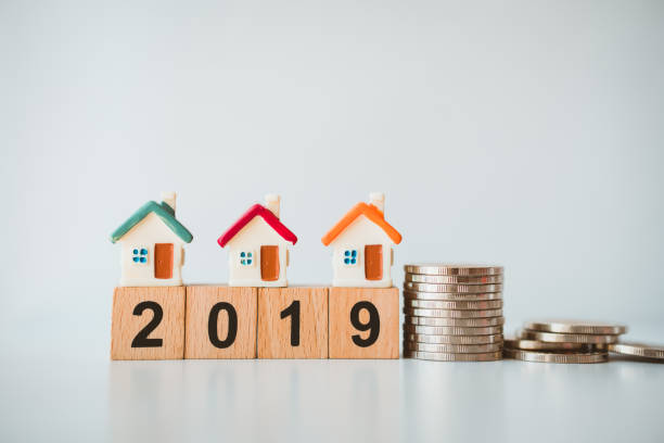 istock Miniature house on wooden block year 2019 1089361622
