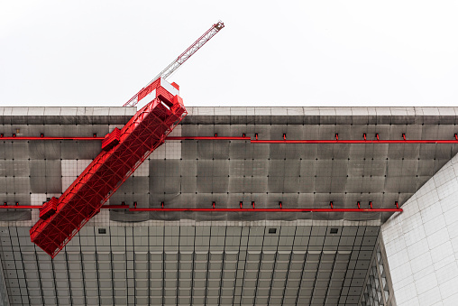 Paris, France - May 23, 2014: Repair on Grande Arche. La Defense, Financial District in Paris, with commuters and tourists. La Defense is a modern district in Paris with skyscrapers and big squares.