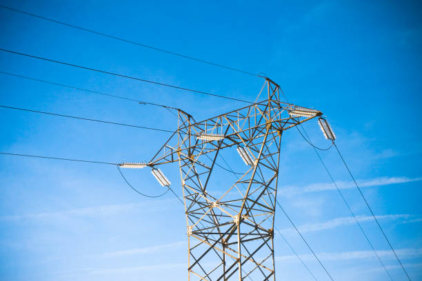 istock Power tower and transmission lines on blue background 1089363680