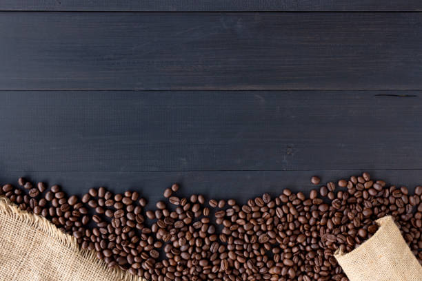 istock coffee beans in burlap sack on old wooden background. top view 1089363930