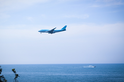 An airplane flying above the sea to land