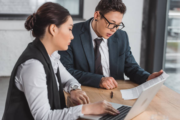 istock serious young business people working with laptop and contract in office 1089367230