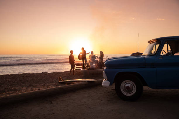 family party on the beach in california at sunset - journey retro revival travel old fashioned imagens e fotografias de stock