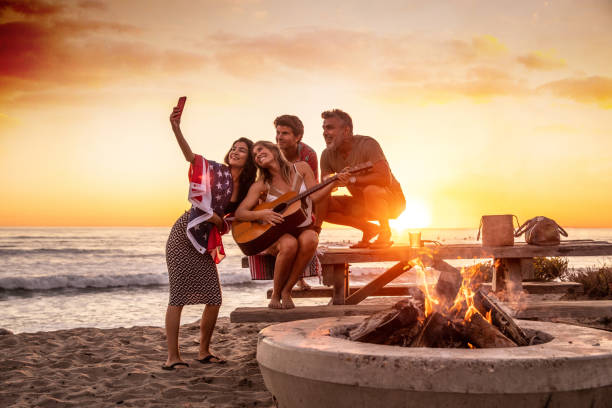 Family party on the beach in California at sunset Family party on the beach in California at sunset family bbq beach stock pictures, royalty-free photos & images