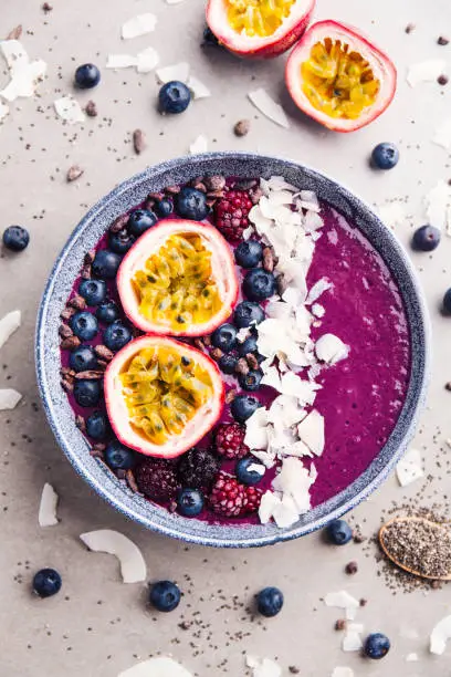 Photo of Smoothie acai bowl served in bowl on grey table