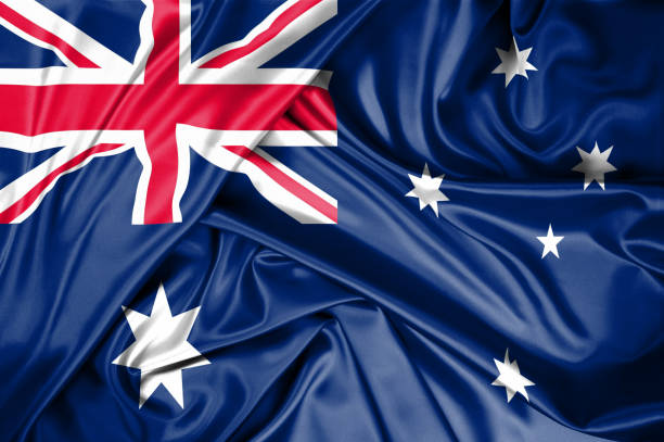 national flag of australia hoisted outdoors with sky in background. australia day celebration. front view - australia australia day celebration flag imagens e fotografias de stock