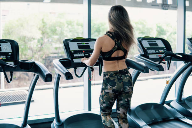 istock Young fit woman doing running exercise in gym 1089376746